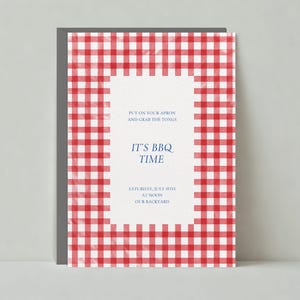 May include: Red and white gingham picnic blanket invitation with the text "Put on your apron and grab the tongs. It's BBQ Time. Saturday, July 18th at noon. Our backyard."
