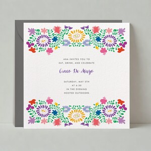 May include: A white invitation card with colourful floral border designs. The text reads "ANA INVITES YOU TO EAT, DRINK, AND CELEBRATE Cinco De Mayo SATURDAY, MAY 5TH AT 6:30 IN THE EVENING HOSTED OUTDOORS".