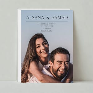 May include: Wedding invitation featuring a smiling couple. The card has a gradient blue background with the names ALSANA & SAMAD at the top. Text below reads "ARE GETTING MARRIED! JULY 18TH 1998 BROOKLYN Invitation to follow."