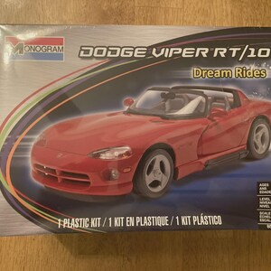 May include: A Monogram model kit box featuring a red Dodge Viper RT/10 convertible. The box includes the text "Dream Rides" and "1 Plastic Kit". The model is at a 1:25 scale.