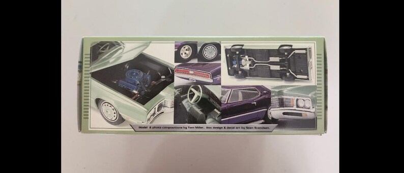May include: A model car kit box with multiple images of a classic car. The images show the car's engine, wheels, interior, and exterior. The box is green and white with text at the bottom.
