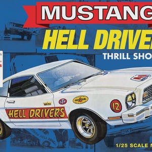 May include: A white Mustang Hell Drivers model car kit. The box features the car with the words "MUSTANG HELL DRIVERS" in large yellow letters. Includes special features like pad-printed drag sticks and an expanded decal sheet. Scale 1/25.