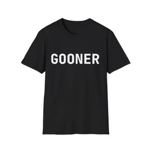 May include: Black t-shirt featuring the word "GOONER" in large, white capital letters. The shirt has a classic crew neck and short sleeves. The material looks like a comfortable cotton blend.