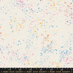 May include: Cream-coloured fabric with a vibrant splatter design. The pattern consists of small, irregular dots in blue, pink, yellow, and orange, spread across the material. The text "RUBY STAR SOCIETY" is at the bottom.