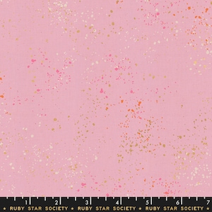 May include: Pink fabric with a speckled pattern of gold, pink, and orange dots. The fabric is a cotton blend and is perfect for quilting, sewing, and crafting.