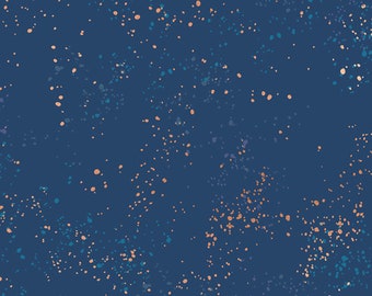 May include: A navy blue fabric with a scattered pattern of small, light blue and peach-colored dots. The fabric has a speckled, textured look.