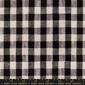 May include: Black and white checkered fabric. The pattern is a classic gingham design, with evenly spaced squares of black and off-white. The fabric has a textured appearance. The text at the bottom reads "RUBY STAR SOCIETY".