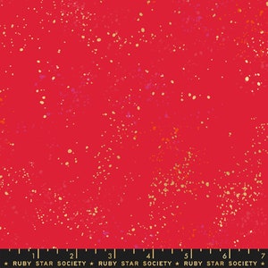 May include: Red fabric with a scattered gold and orange splatter pattern. The fabric has a subtle texture.