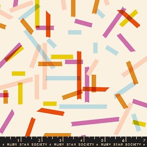 May include: Cream-colored fabric with a repeating pattern of colorful, overlapping rectangular shapes in shades of orange, pink, yellow, and blue. The text "RUBY STAR SOCIETY" is printed at the bottom.