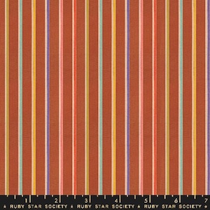 May include: A rust-colored fabric with vertical stripes in shades of yellow, orange, pink, green, and purple. The fabric is labeled "Ruby Star Society" with numbers 1 through 7.