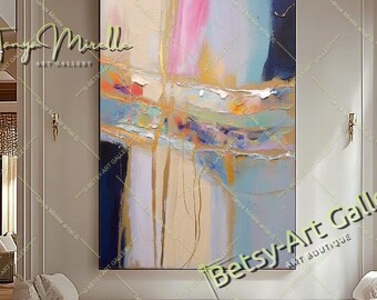 May include: A large vertical abstract painting featuring a blend of soft pink, light blue, cream, and deep navy blue tones. The composition includes textured horizontal bands, vertical gold-toned streaks, and layered paint strokes on a canvas.