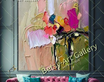 May include: A rectangular canvas painting featuring thick, textured impasto brushstrokes in shades of pink, magenta, olive green, gold, and cream. The artwork displays abstract floral-like shapes and layered paint applications on a wall.