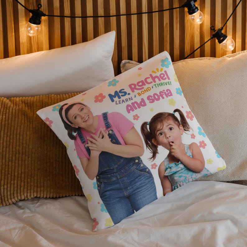 May include: A white pillow with a colorful design featuring two women. The text on the pillow reads "Ms. Rachel Learn, Bond, Thrive! And Sofia".