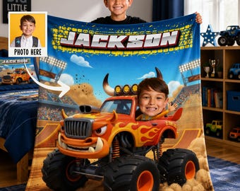 May include: A personalized fleece blanket featuring a vibrant orange monster truck with flame graphics, a stadium background, and the name JACKSON printed in bold letters. The design includes a custom photo insert of a smiling child.
