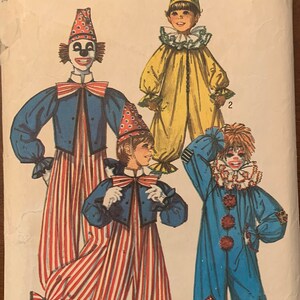 May include: Simplicity pattern 7162 for boys' and girls' clown costumes. The pattern features illustrations of four different clown outfits, including striped pants, jackets, and hats. The price is $1.50 in Canada.