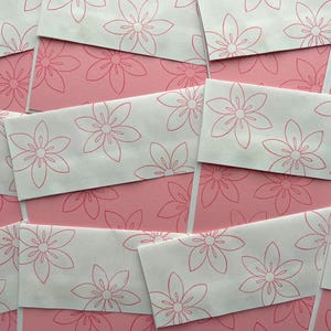 May include: Stationery items with a floral design are displayed. White envelopes with a red outline flower pattern are layered over pink paper with a matching floral print. The image has a delicate and feminine aesthetic.