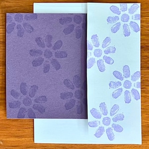 May include: A set of three ceramic mugs with a speckled, matte finish in cream, light grey, and dark grey. Each mug has a simple, minimalist design and a rounded handle.