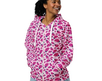 May include: A pink zip-up hoodie with a white zipper and a pattern of pink and black ladybugs.