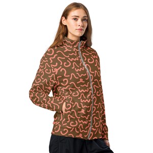 May include: A brown zippered jacket with a pink worm pattern. The jacket has a high collar and a zipper closure.