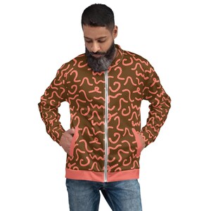 May include: A brown bomber jacket with a pink worm pattern. The jacket has a zipper closure and two pockets.