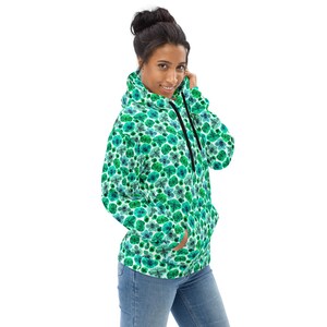 May include: A green and blue patterned hoodie with a drawstring hood. The hoodie has a relaxed fit and a kangaroo pocket.