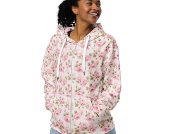May include: A white zip-up hoodie with a pink and green floral pattern featuring roses. The hoodie has a hood with a drawstring and two front pockets.