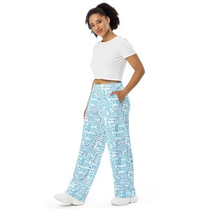 May include: Wide-leg pants with a circuit board pattern in shades of blue and white. The pants are paired with a white crop top. The overall look is casual and modern.