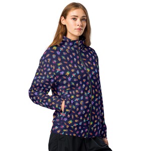 May include: A navy blue jacket with a zipper closure and a colorful pattern of insects and flowers. The jacket has a stand-up collar and long sleeves.