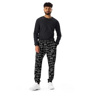 May include: A person wearing a dark gray long-sleeve shirt and black sweatpants covered in white mathematical equations. The person is also wearing white sneakers.