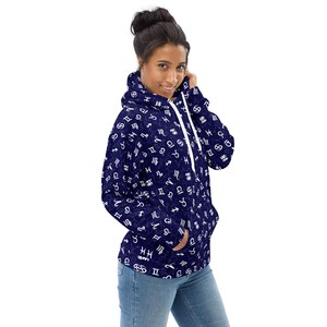 May include: A navy blue hoodie with a white print of astrological signs all over it. The hoodie has a white drawstring and a kangaroo pocket.