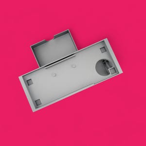 May include: A gray model of a building with a flat roof and a circular opening. The building has a smaller rectangular addition on top.