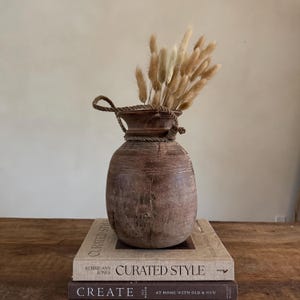 May include: A set of three ceramic mugs with a speckled, matte finish. The mugs are in shades of cream, light gray, and dark gray. Each mug has a simple, minimalist design and a rounded handle.