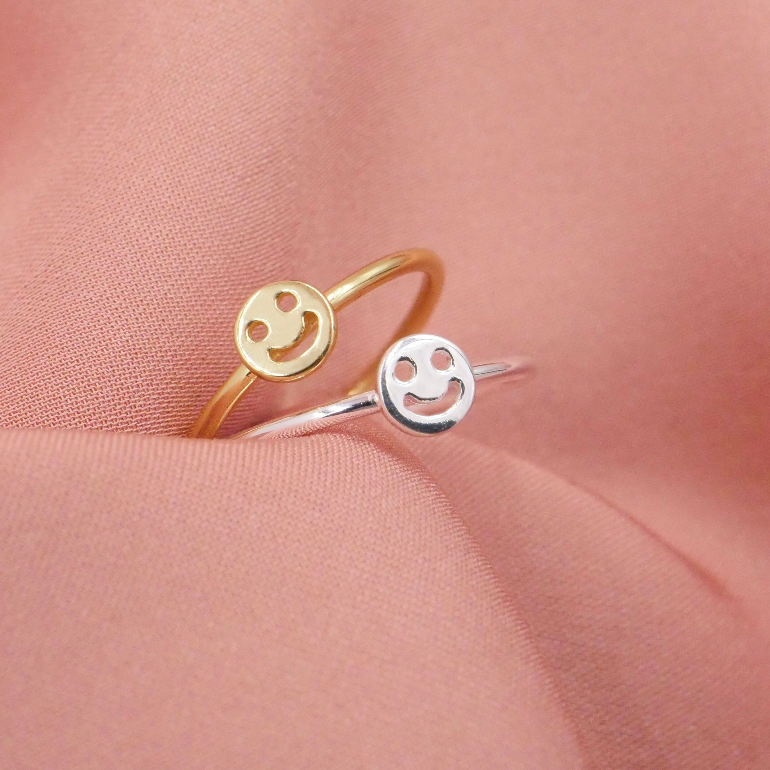 Silver ring with cheap gold smiley face