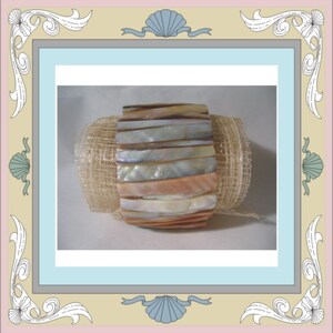 May include: A bracelet made of iridescent mother-of-pearl shell pieces. The bracelet is stacked and has a natural, organic look.