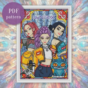 May include: A framed PDF cross-stitch pattern featuring three stylized female figures with vibrant hair colors. The design includes a yellow jacket, blue jeans, and a blue cat. The word "HUNTRIX" is visible.