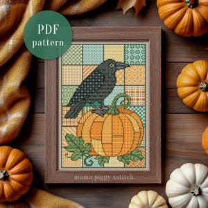 Puede incluir: Un patrón de punto de cruz enmarcado que muestra un cuervo negro sobre una calabaza naranja grande con un fondo de cuadros verdes y amarillos. El texto "PDF pattern" aparece en un círculo verde y "mama piggy xstitch" está en la parte inferior.