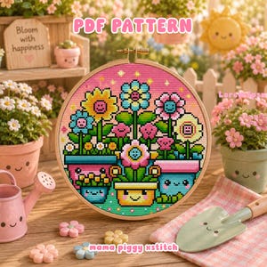 Op de afbeelding: Een ronde borduurring met een kruissteekpatroon van kleurrijke bloemen in lachende potten. Het ontwerp toont diverse bloemen in tinten geel, blauw en roze tegen een roze achtergrond. De tekst PDF PATTERN is zichtbaar.