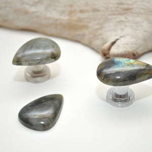 May include: Three teardrop-shaped labradorite gemstone cabinet knobs with silver bases.