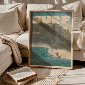 May include: A framed rectangular wall art print featuring a tropical ocean scene with a person surfing a large wave. The text SURF is printed in large white letters at the top, with CHASE THE RUSH, FEEL THE FREEDOM, and EST. 1969 printed below.