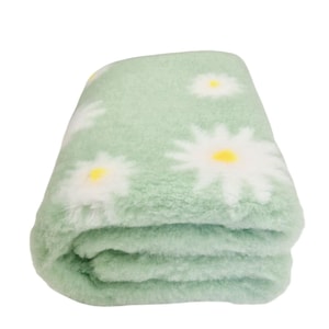 May include: A soft, green throw blanket with a white daisy pattern. The blanket is folded in thirds and is made of a fuzzy material.