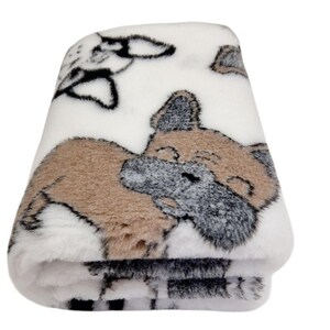 May include: White plush blanket featuring a brown and grey dog illustration. The dog is lying down with its head turned to the side. The blanket is soft and fluffy.