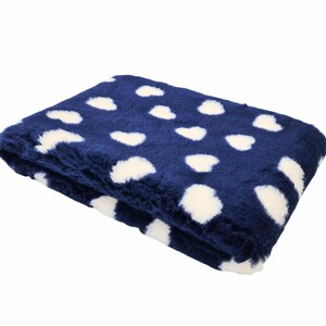 May include: A folded blanket with a navy blue base and a pattern of white, cloud-shaped designs. The blanket has a soft, plush texture, giving a cosy and comfortable feel. The design is simple but visually appealing. The blanket is folded.