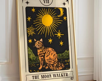 May include: Framed tarot card art featuring an orange tabby cat with a black background, yellow sun, and stars. The text "THE MOON WALKER" is at the bottom. The frame is gold.