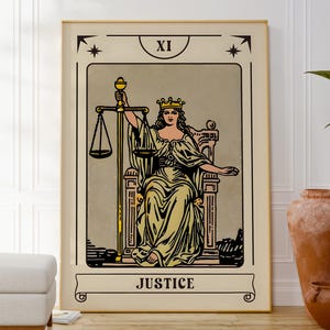 May include: A framed tarot card print featuring the Justice card. The artwork depicts a robed figure seated on a throne, holding scales and a sword. The card is labeled "JUSTICE" at the bottom, with the Roman numeral "XI" at the top.