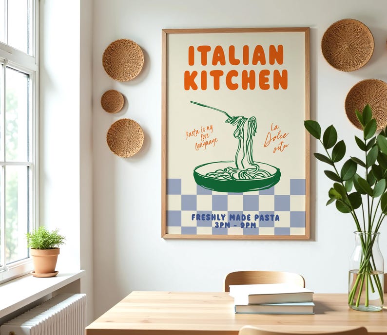 May include: A framed poster with a white background and a blue and white checkered pattern at the bottom. The poster features a green illustration of a bowl of pasta with a fork and text that reads "ITALIAN KITCHEN", "Pasta is my love language", "La Dolce Vita", and "FRESHLY MADE PASTA 3PM-9PM".