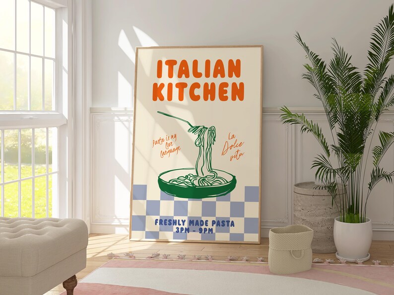 May include: A poster with the text "ITALIAN KITCHEN" in orange and green lettering. The poster features a green illustration of a pan of pasta with the text "Pasta is my love language" and "La Dolce Vita" in the background. The poster also includes the text "FRESHLY MADE PASTA 3PM - 9PM".
