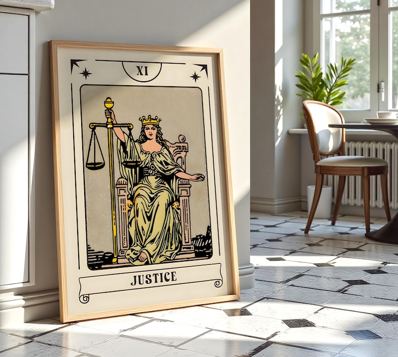 May include: A framed tarot card print of the Justice card. The artwork features a woman in a yellow gown holding scales and a sword, seated on a throne. The card is labeled "XI" at the top and "JUSTICE" at the bottom, with a beige background.
