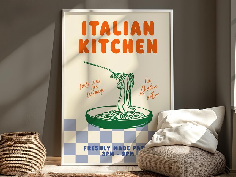 May include: A white framed poster with an orange and green illustration of a plate of pasta with the text "ITALIAN KITCHEN" in orange and green. The text "Pasta is my love language" and "La Dolce Vita" are written in cursive on the poster. The poster also includes the text "FRESHLY MADE PASTA 3PM-9PM".