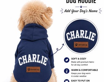 May include: A navy blue dog hoodie with the name "CHARLIE" in white lettering. The hoodie has a brown patch with a paw print and the brand name "Domeboog". The text "CUSTOM NAME DOG HOODIE" is displayed above the dog.