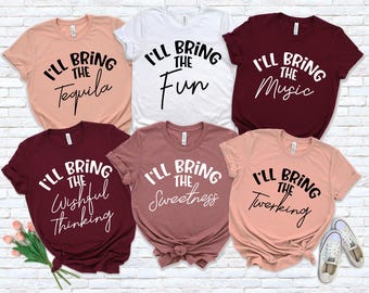 May include: Six different t-shirts with the text "I'll bring the" followed by a different word on each shirt. The words are "Tequila", "Fun", "Music", "Wishful Thinking", "Sweetness", and "Twerking".